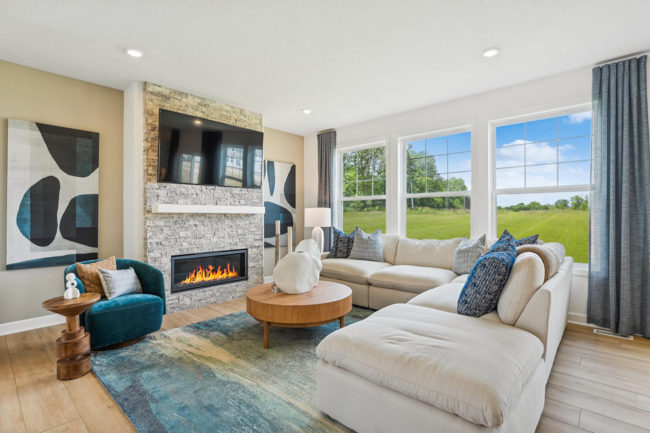 (Photo of a decorated model, actual homes finishes will vary) Cozy up by the fireplace.