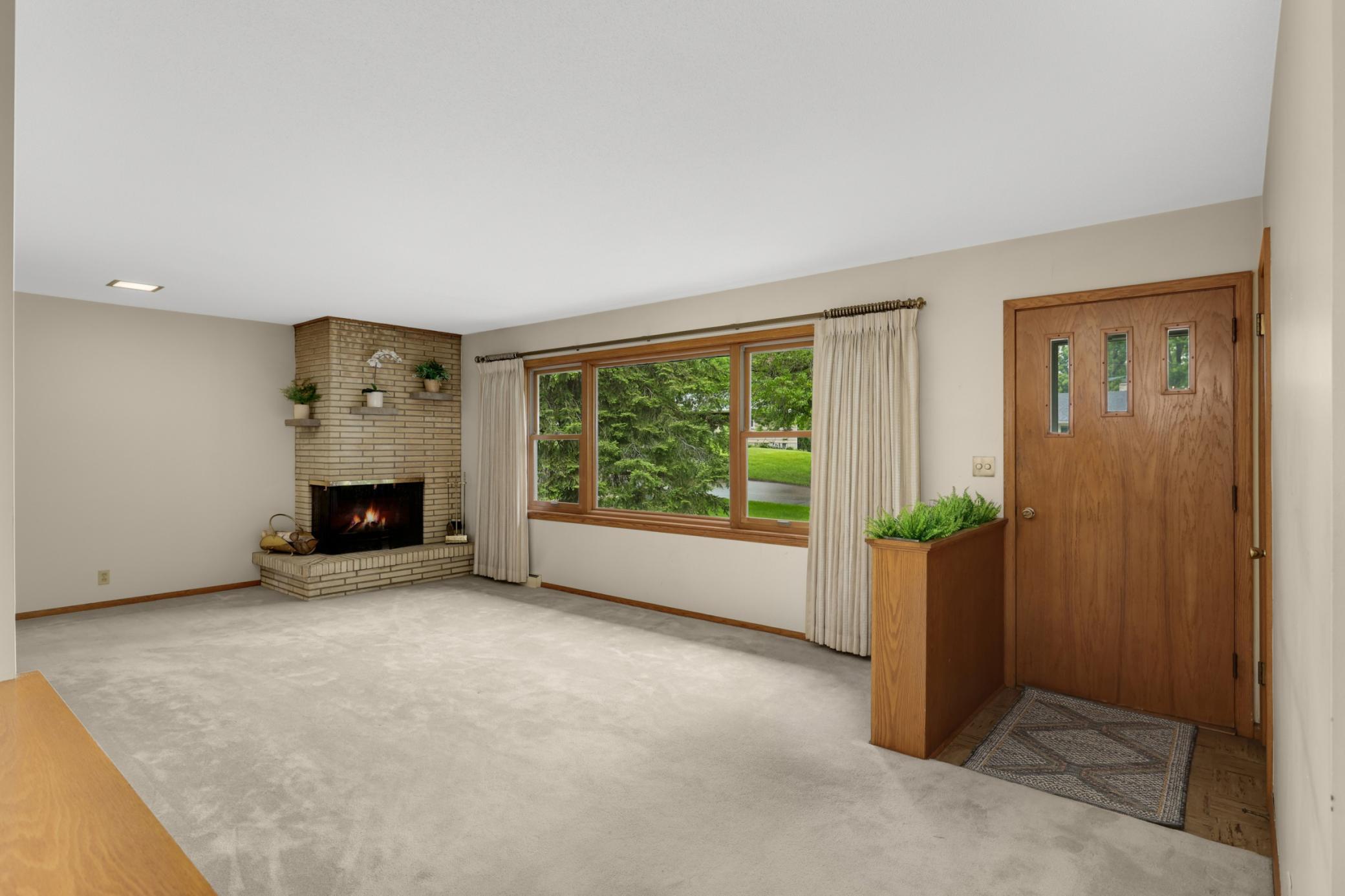 Enjoy hardwood floors underneath the carpet and updated Anderson windows throughout.