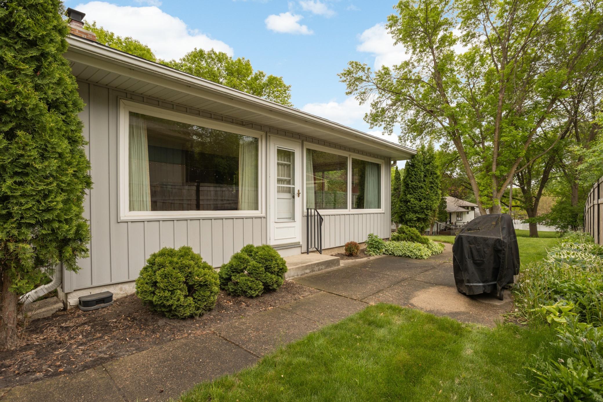 The side patio is so convenient for grilling and entertaining, just off the sunroom.