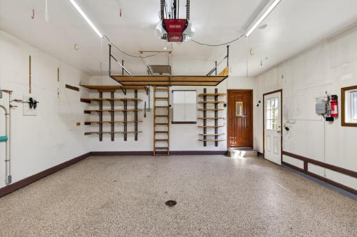 Attic storage has flooring and insulated, shelving, bike suspended storage,