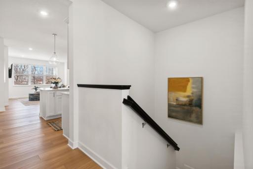 (Photo of a decorated model, actual homes finishes will vary) The stairs lead to the lower level.