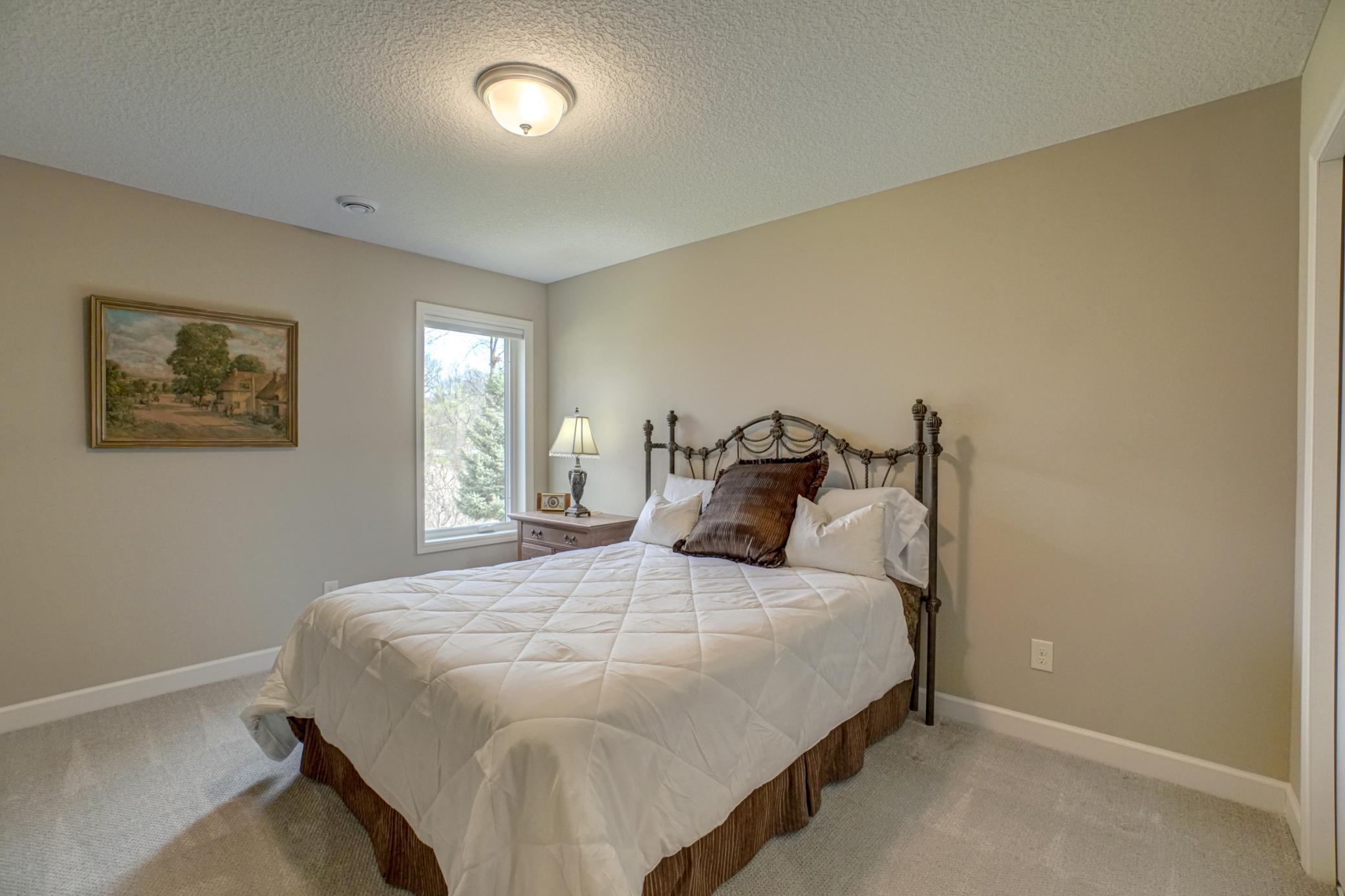 This third bedroom in the lower level provides comfort and privacy