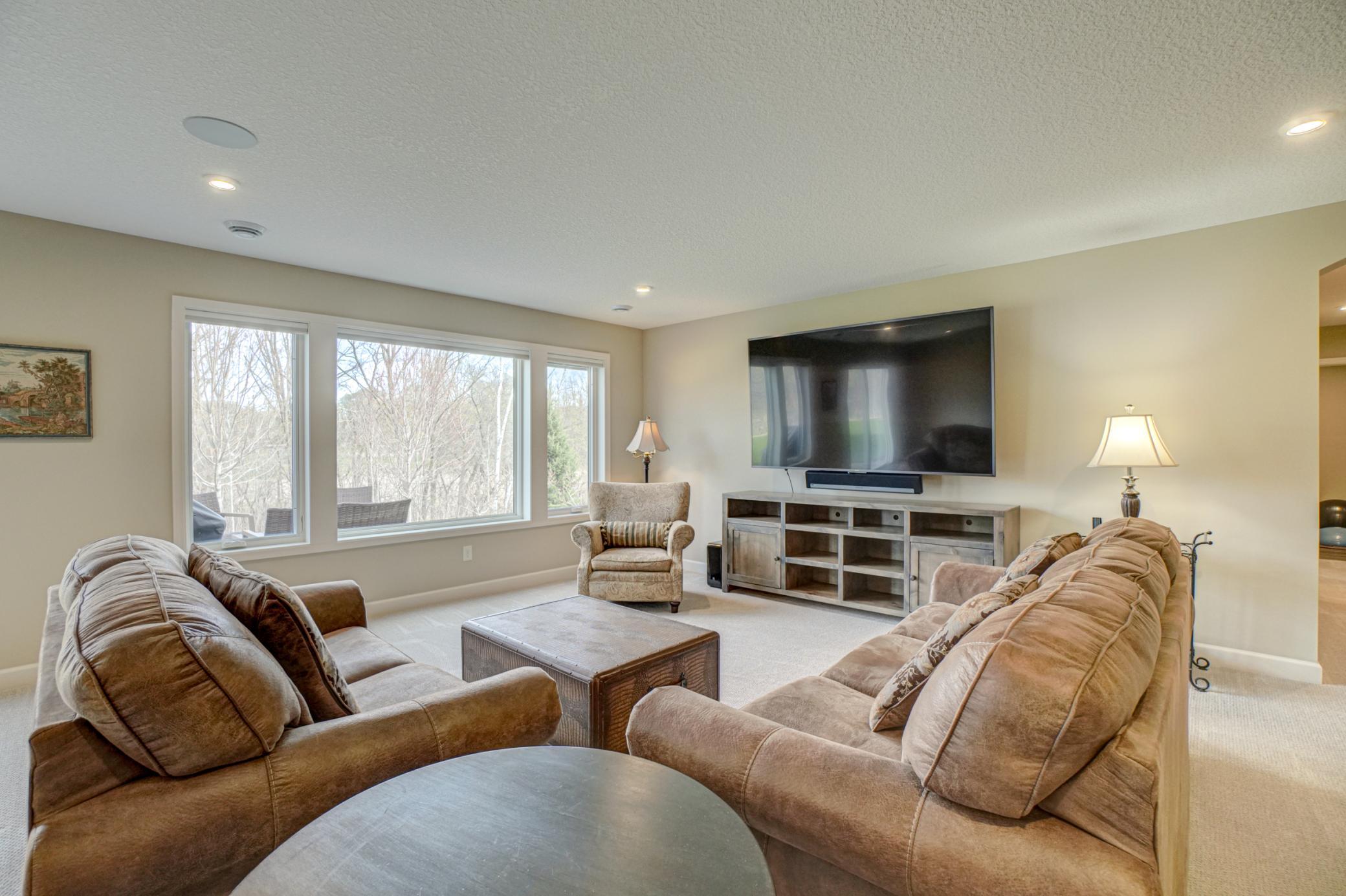 The fully finished walkout lower level is designed for entertaining, complete with two additional bedrooms, a flex space, a wet bar, and easy access to the paver patio