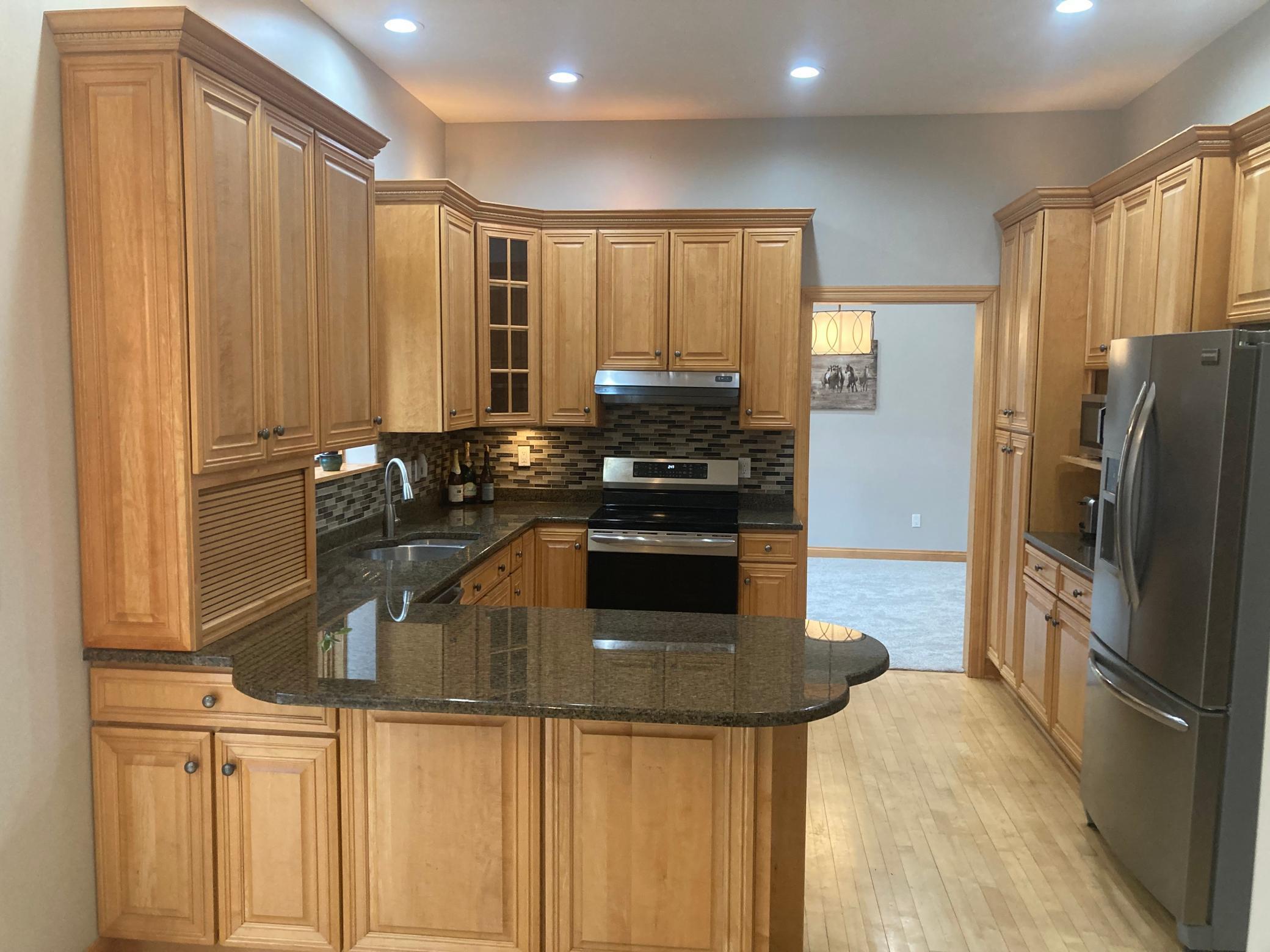 kitchen features granite tops & offers both a formal & informal dining room