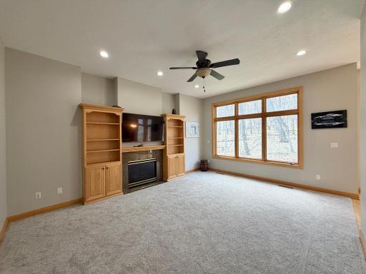 living room with gas fireplace & custom built-ins