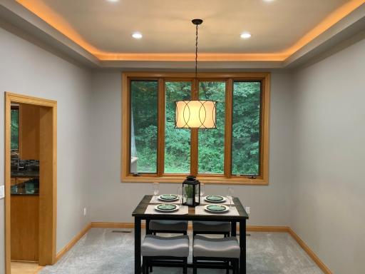 dining room with backlit trey ceiling