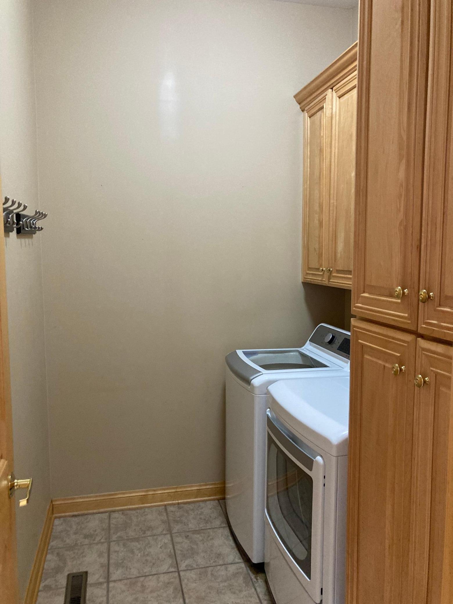 Main floor laundry with ample cabinet space