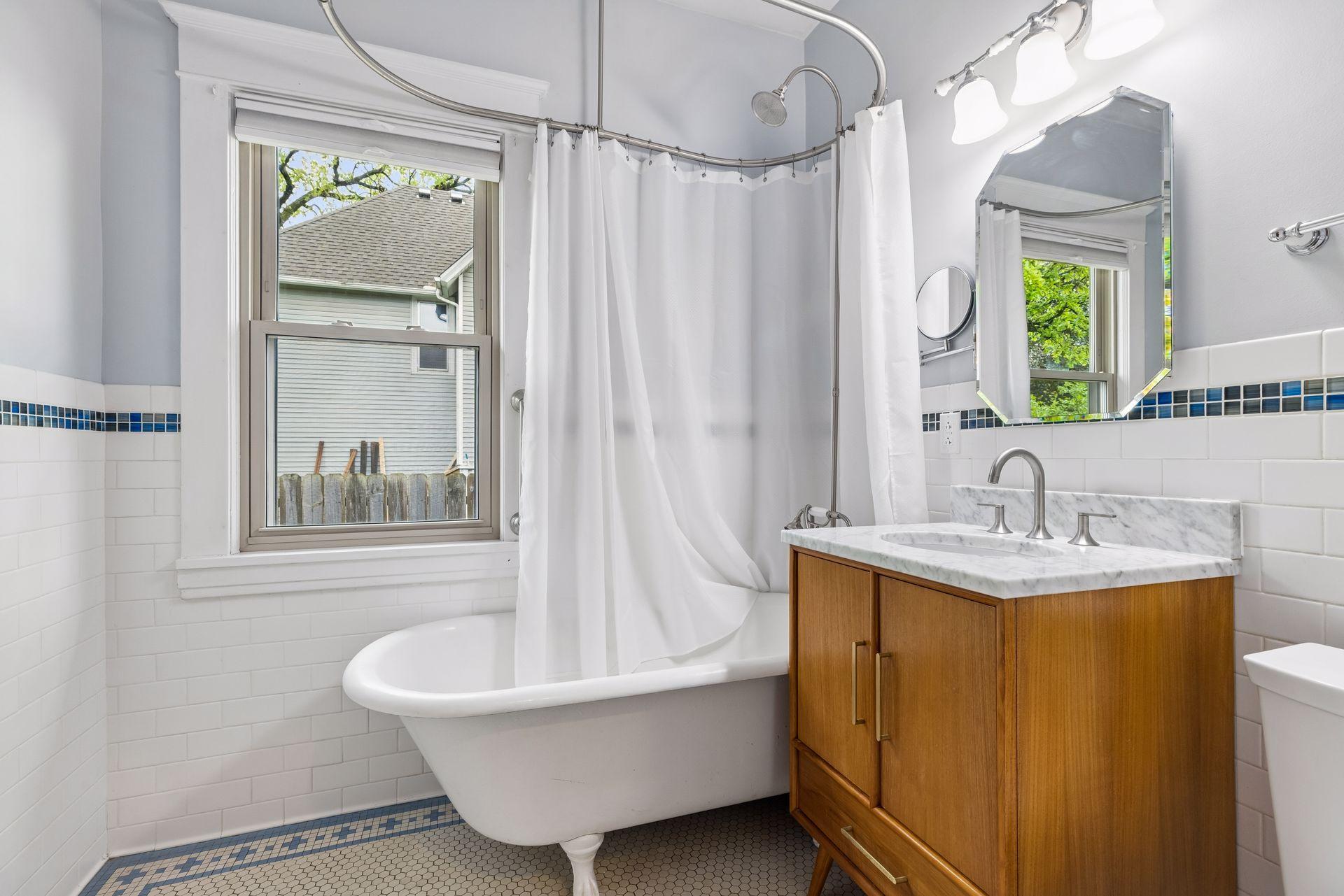 Main floor full bath with claw foot tub and new vanity in 2025.