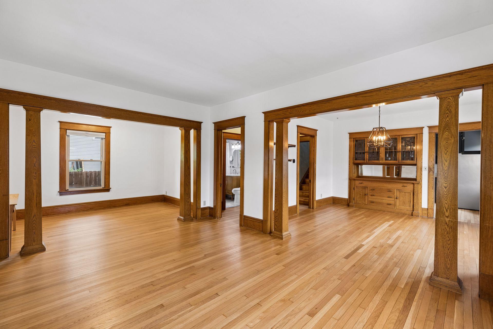 The flawless hardwood floors have been freshly refinished on the main AND upper level! Note the symmetrical woodwork and columns between the rooms.