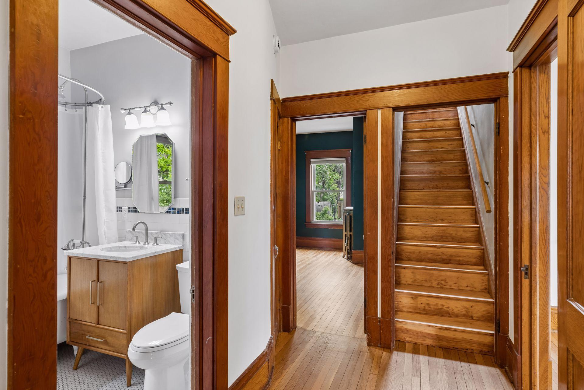 Hallway to main floor bath, bedroom and staircase.