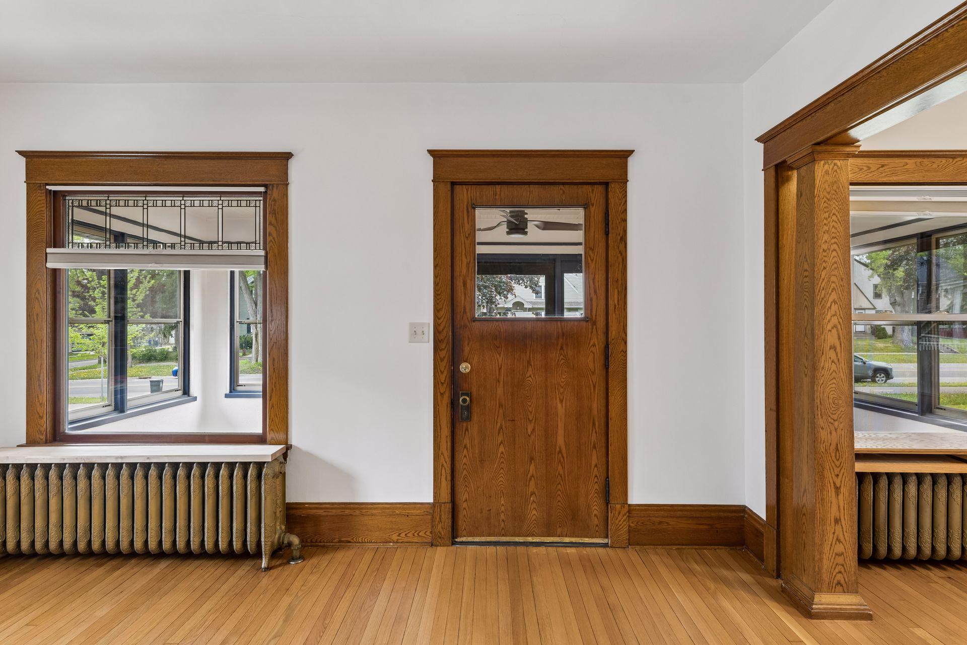 The warm and welcoming interior feature original natural woodwork, leaded glass windows, and 1915 Craftsman style details.