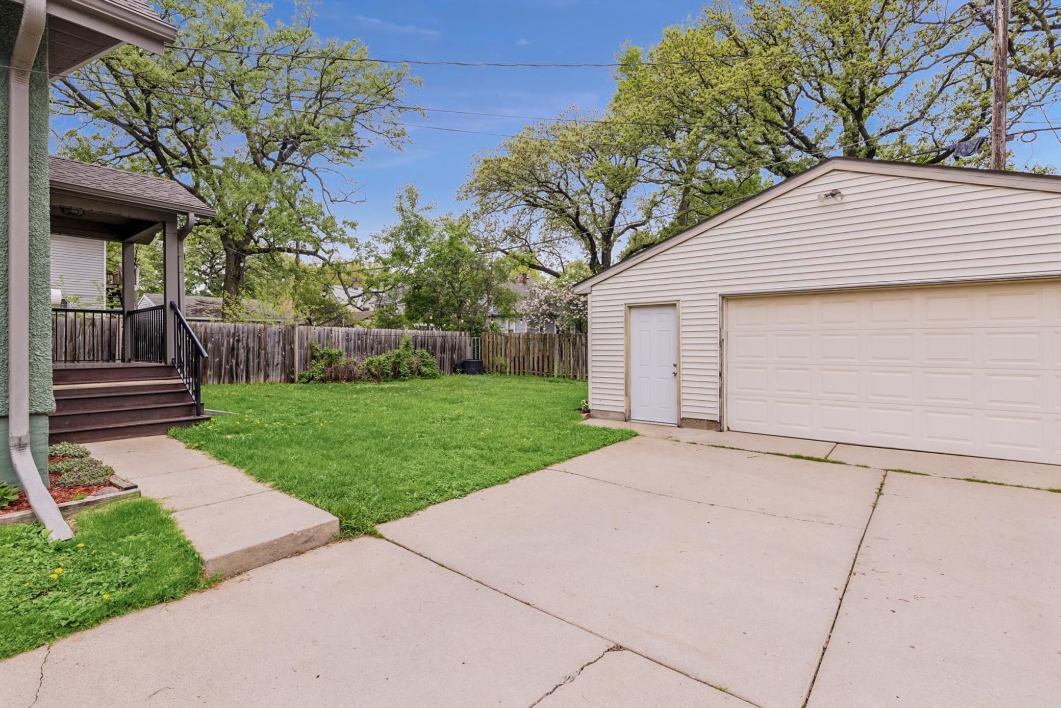 Oversized 2car garage (26x22) built in 1998 with built-in shelving and long concrete driveway.