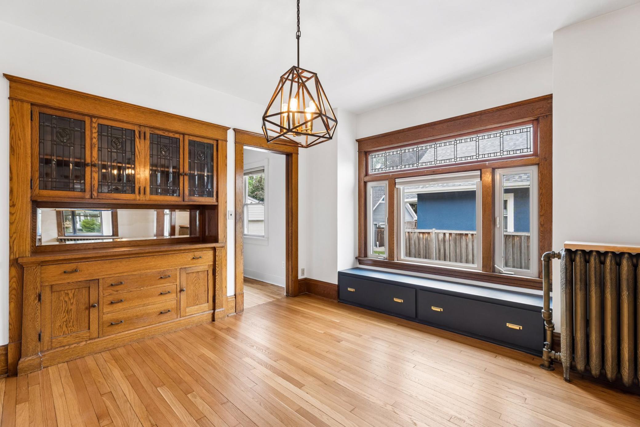 Classic formal dining room with built-in buffet featuring inlaid mirror and glass display cabinets.
