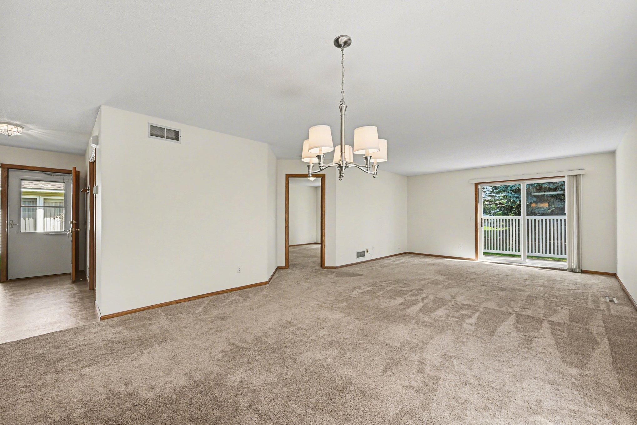 The bright entryway features a front door with sidelights and a convenient coat closet. This functional space flows seamlessly into the main living area, welcoming you into the home's open and thoughtful layout.