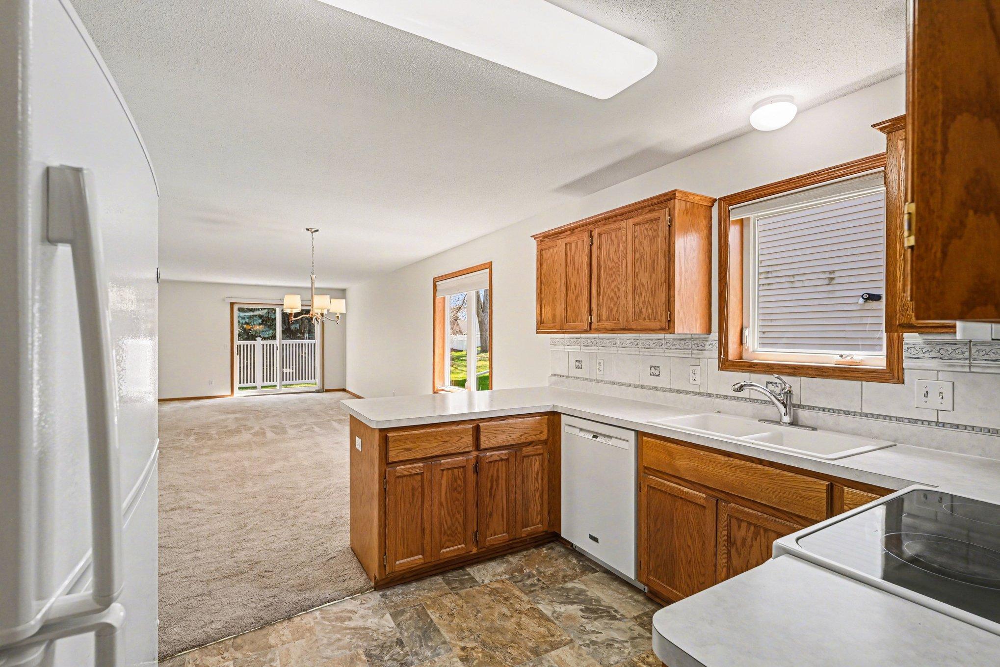 This kitchen view highlights the short, easy trip from the garage and laundry room/mud room—perfect for unloading groceries! This thoughtful, efficient layout is designed for the busy homeowner seeking maximum convenience and effortless living.