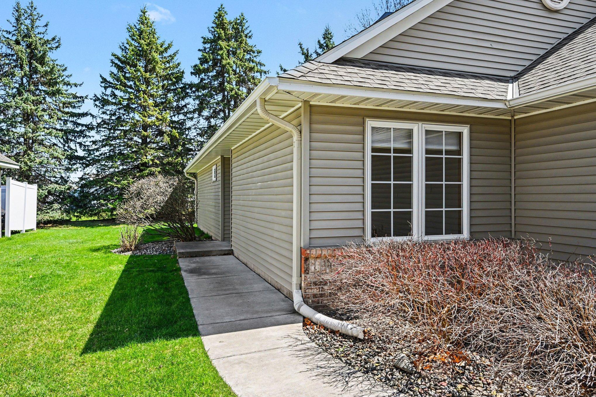A concrete drive & sidewalk leads to this move-in ready detached townhome. Enjoy a private backyard w/mature pines. With the HOA handling all snow & yard work, you can skip the chores & simply enjoy easy, one-level living! The roof was done in 2022!