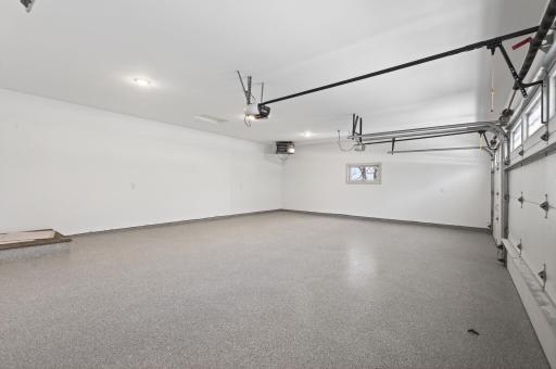 Fully finished and heated garage with durable epoxy floors and a rough-in for a future electric vehicle charger.