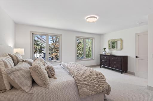 This space showcases dual windows and soft neutral tones, creating a calm getaway.