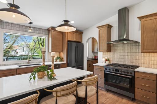 A closer look showcasing this kitchen's premium appliances and stylish backsplash.