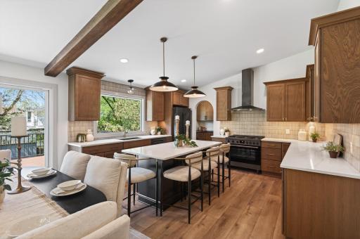 An expansive kitchen island provides casual seating along with extra storage and prep space.