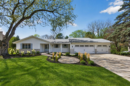 New landscaping is scheduled, including updated edging, fresh mulch, new plantings, and stepping stone pavers from the existing walkway to the front entry. Photo is AI-edited to show vision and is NOT an exact of final results.