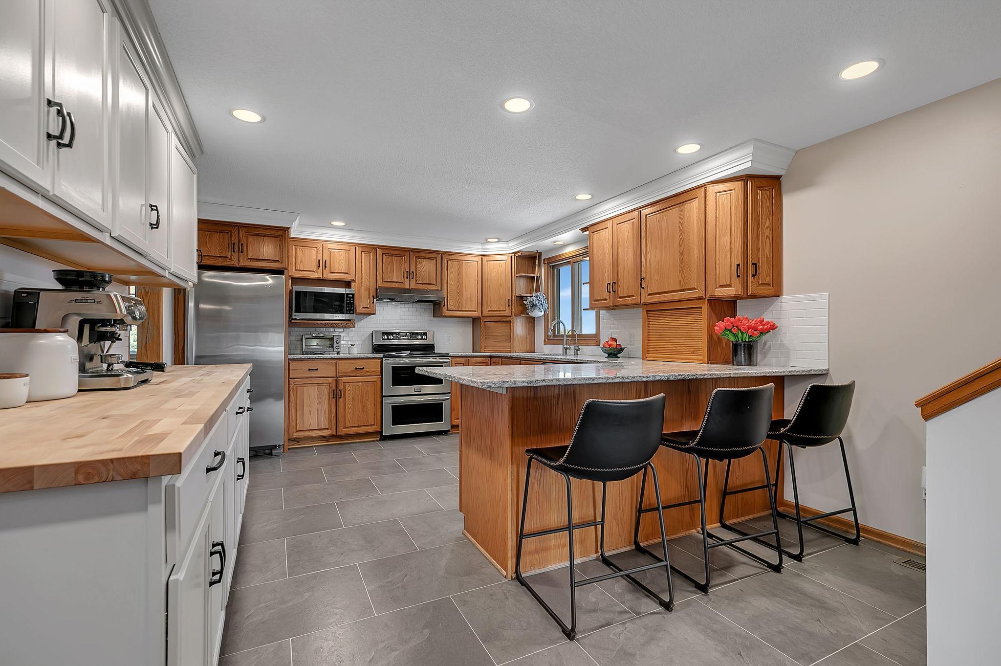 Updated kitchen with granite counters, luxury vinyl plank flooring and double convection oven.