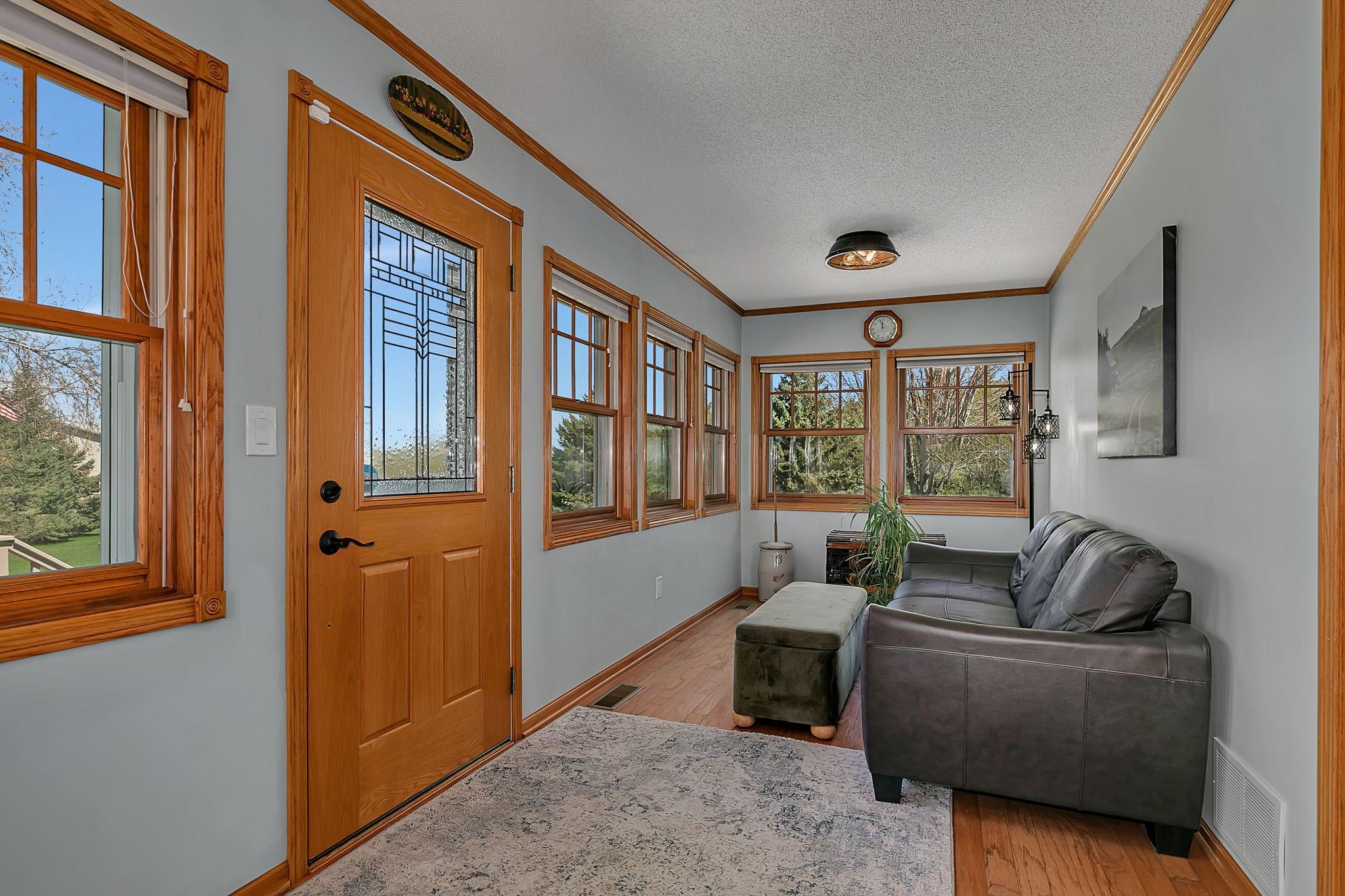 This bright and cheery four season sun room is located off the living room and offers a great place to relax and unwind.