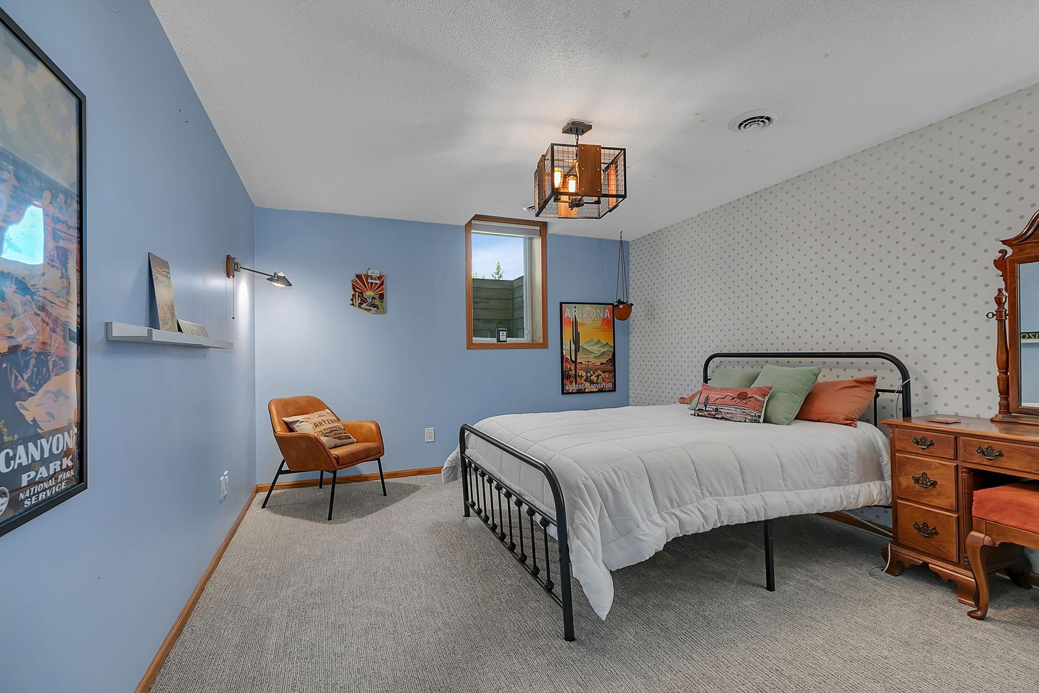 Lower level bedroom featuring updated lighting and carpet with spacious closet.