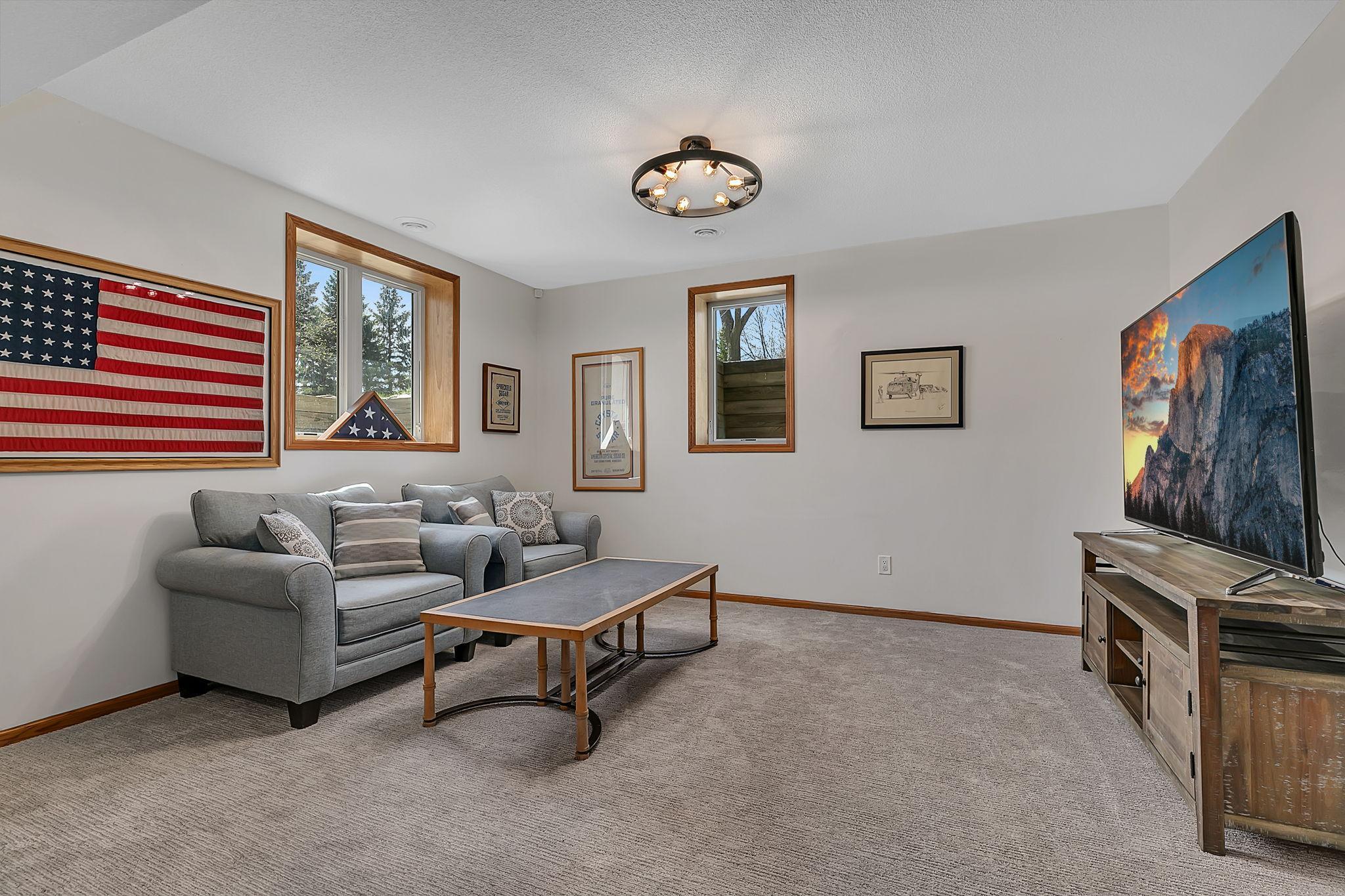 Another view of the family room with updated carpet and lighting.