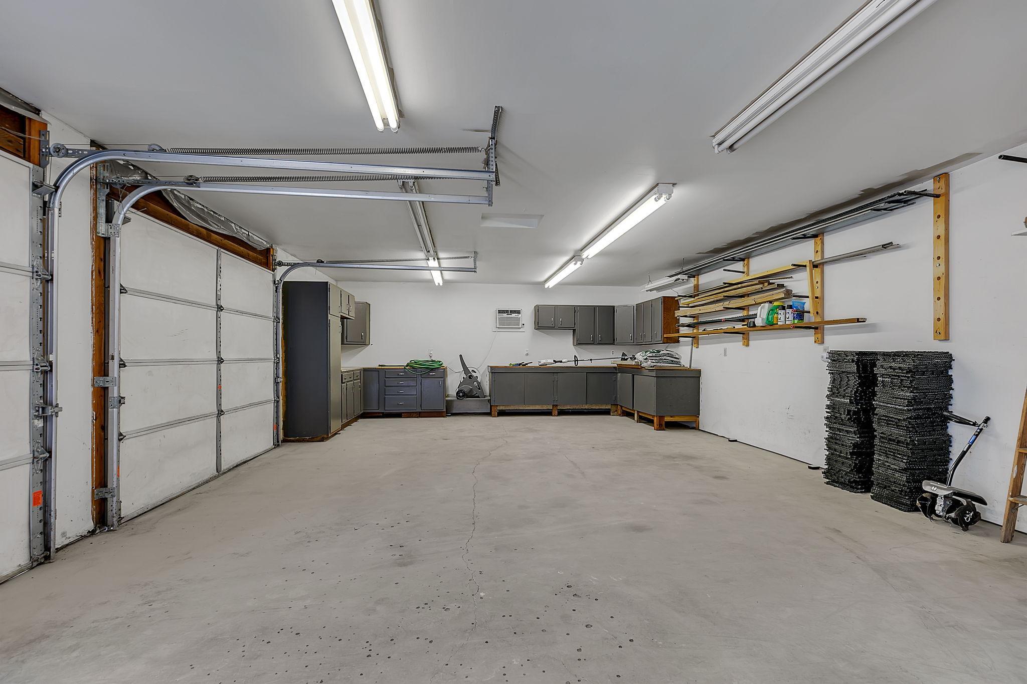 Detached two stall garage features great storage as well as an a/c unit.