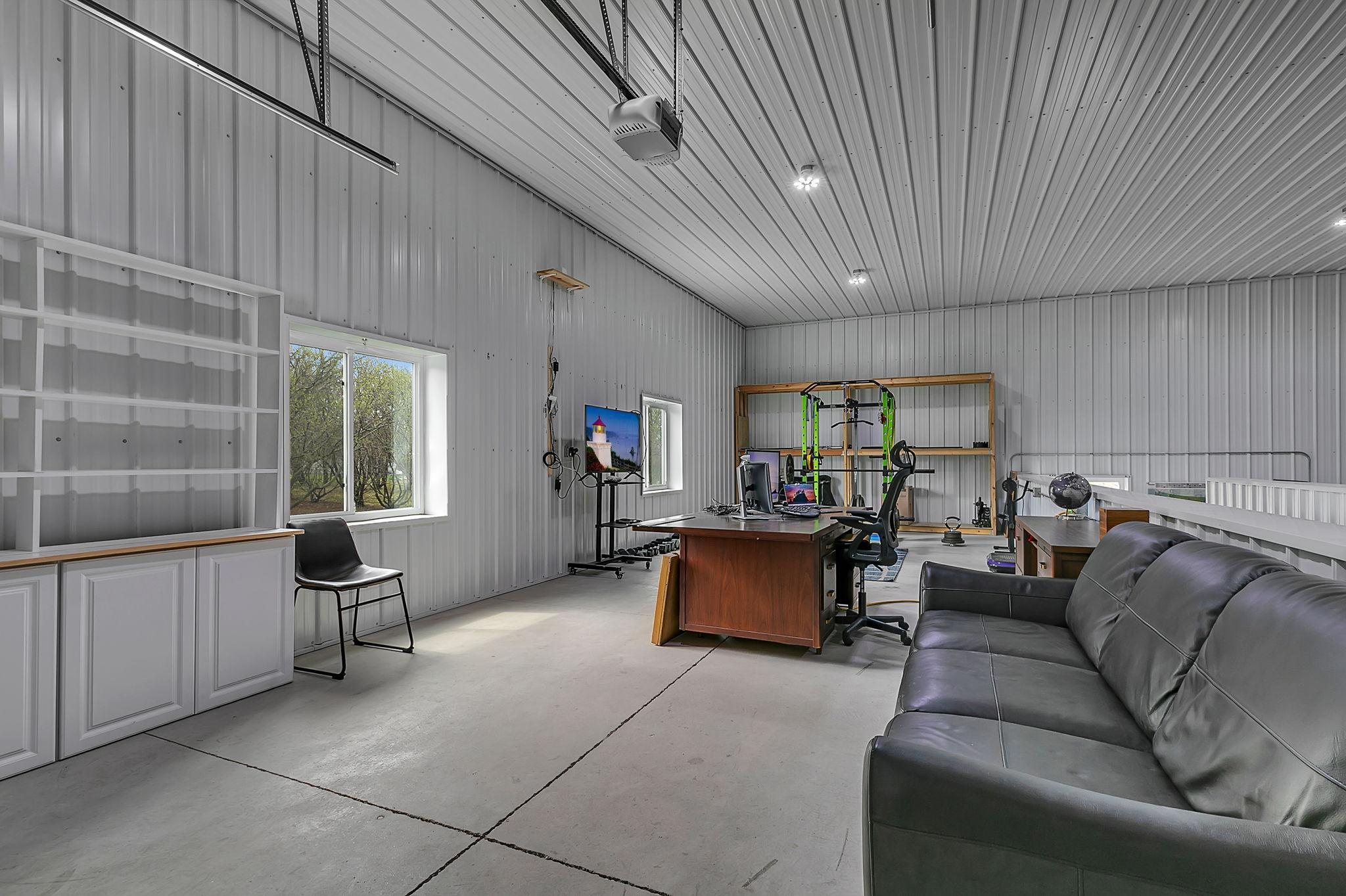 Spacious, bright, heated and finished - the upper level loading dock area is a flexible space and is currently being used as an office space and workout area.