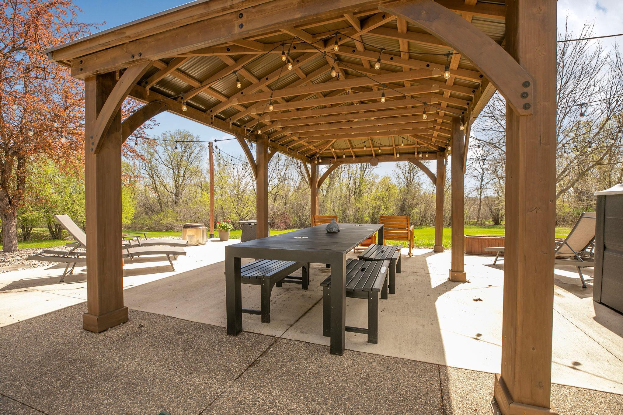 Outdoor living at its best with a 30x36 patio, covered seating area, great grilling space and a Jacuzzi swim spa!