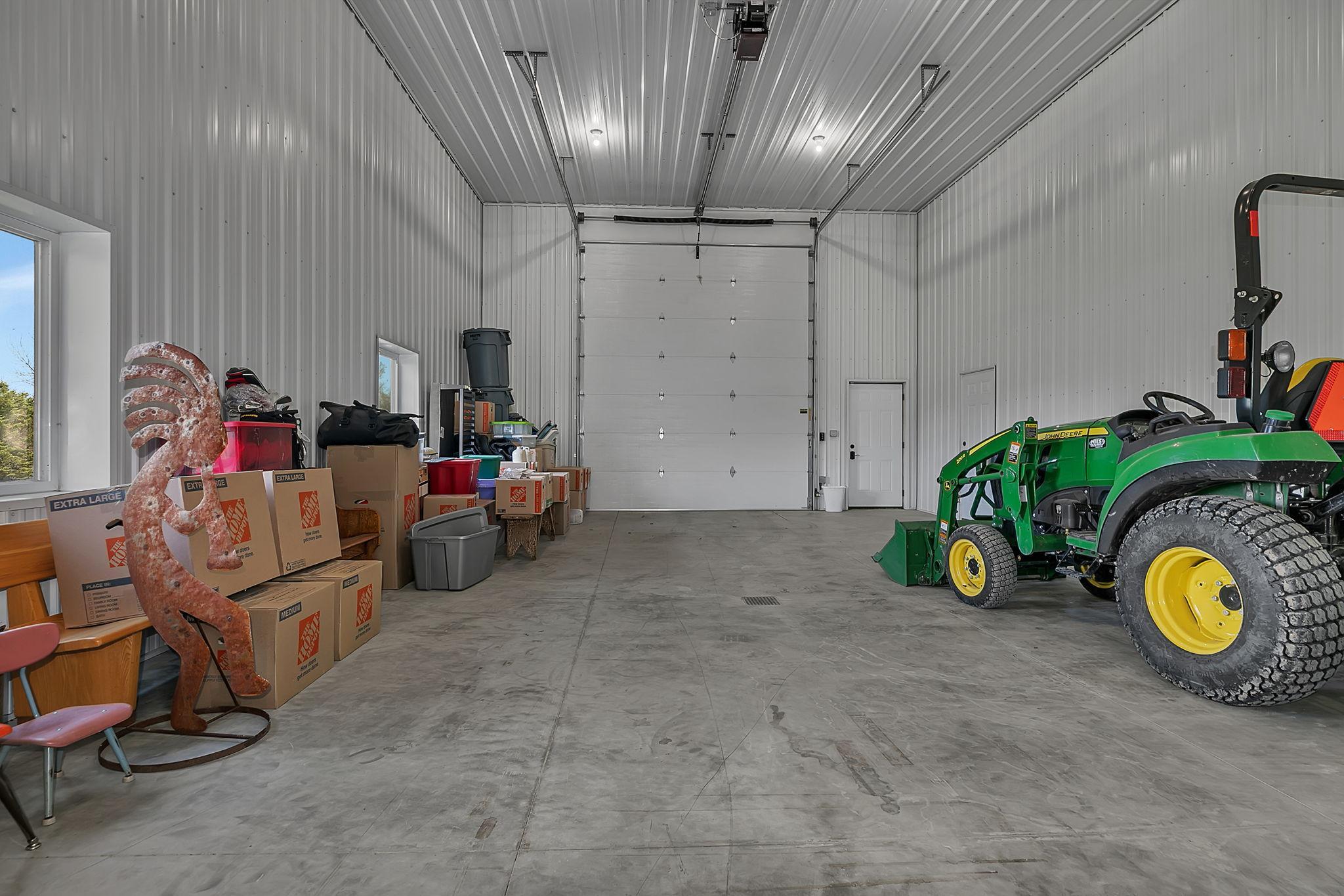The 4th stall of this outbuilding has a 14' overhead door with GDO and offers additional storage. This space is not currently heated.