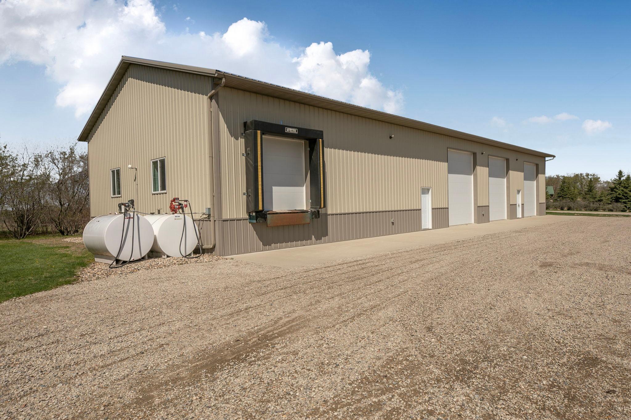 40x104 Heated outbuilding with loading dock, three 14' overhead doors, concrete apron. Ideal for work, storage, hobbies or a home-based business!