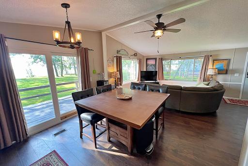 Dining area with sliding doors to lakeside deck and panoramic views