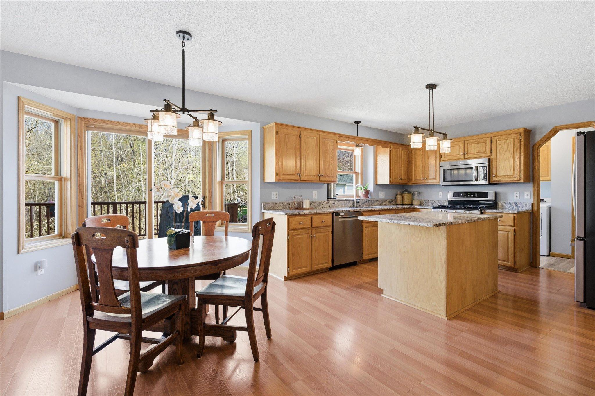 A Cooks Kitchen and Dinette with access to backyard deck