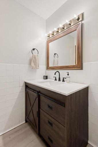 Updated with newer stylish vanity, great lighting and tile.