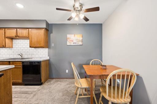 Dining area, and kitchen with great lighting. The far wall that is grey could accommodate a hutch.