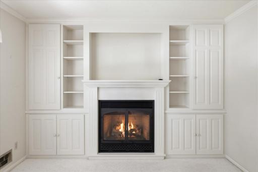 Gas fireplace surrounded by built-in cabinets