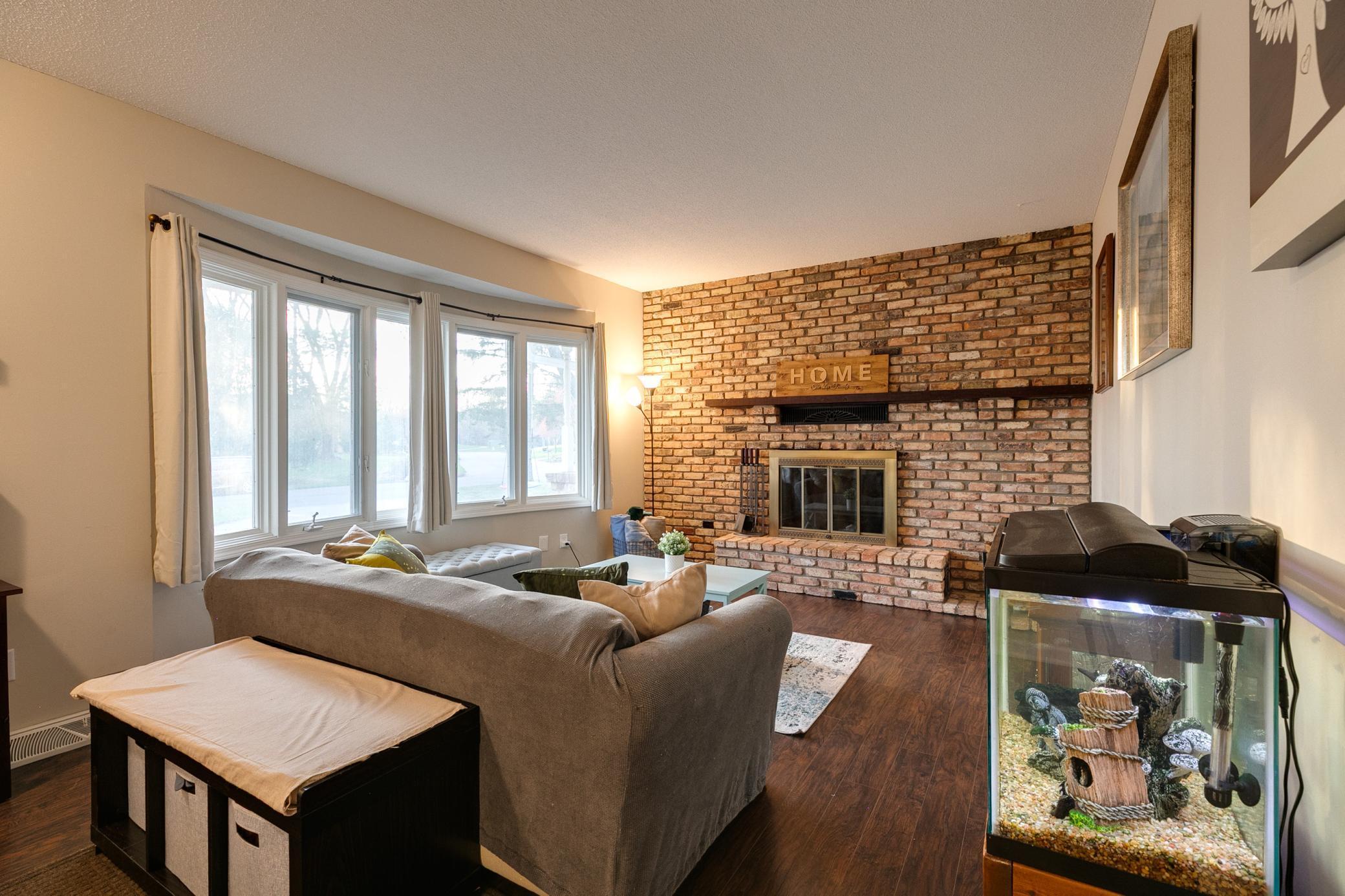 Bright living room featuring large bay windows that allow natural light in.