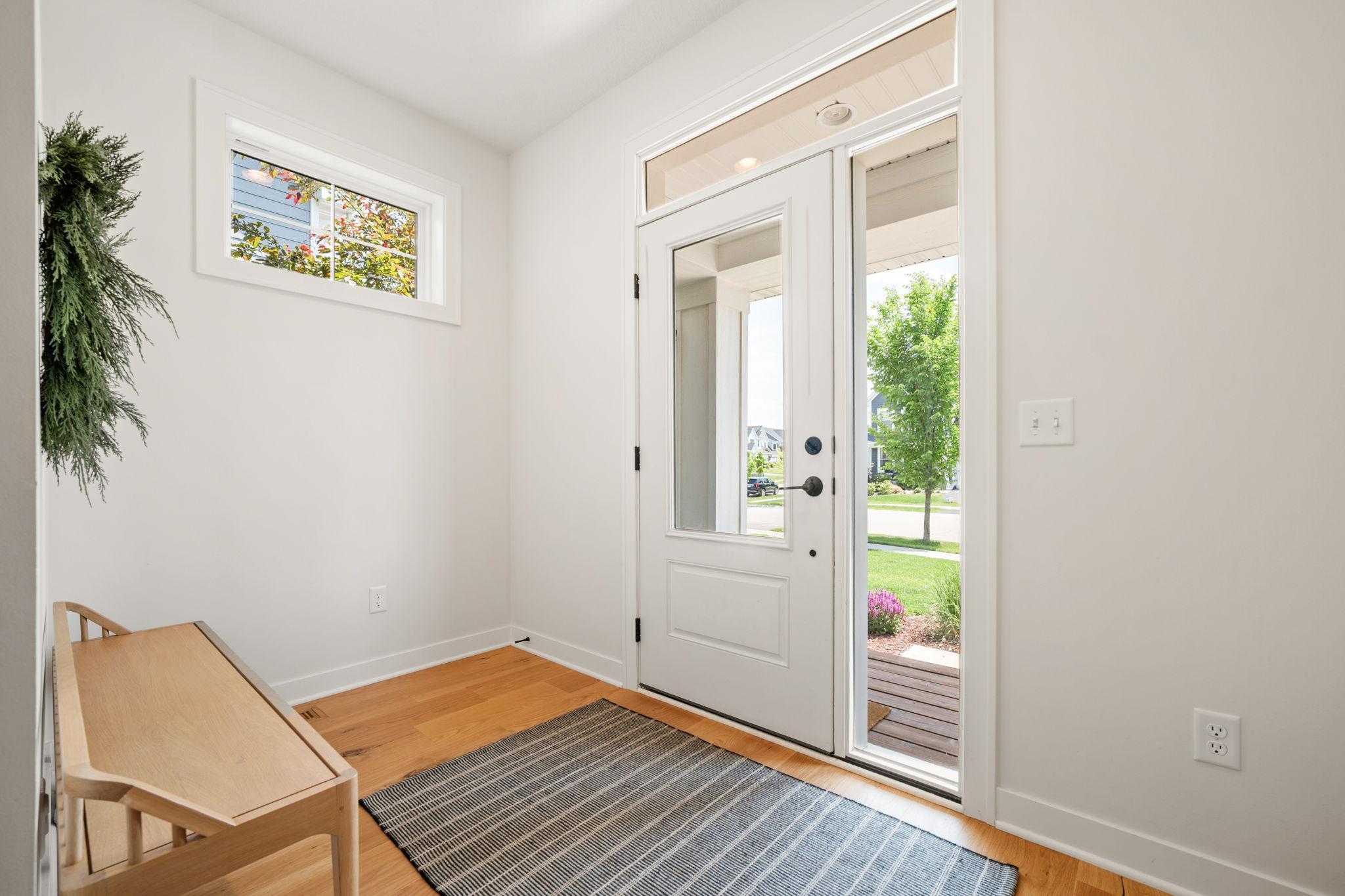 Entry features charming partial glass entry door with sidelights flood the space with sunlight