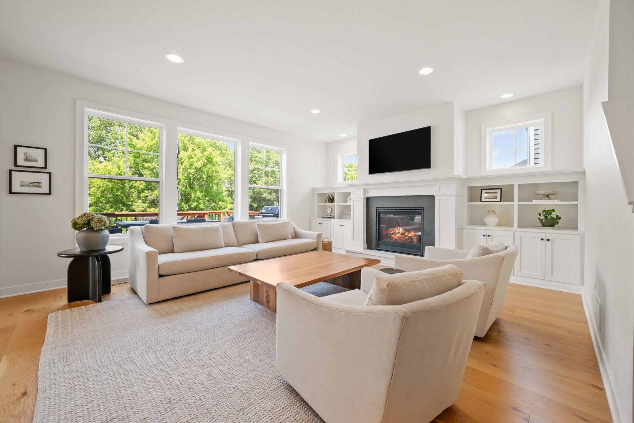 Great Room features gas fireplace with granite surround and enameled mantel
