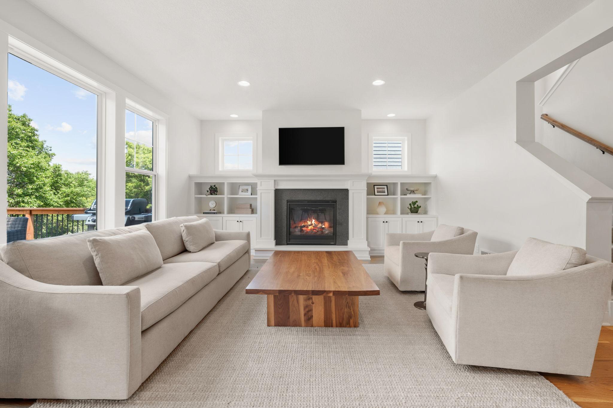 Pair of built-in cabinets frame the fireplace and offer storage and display shelving