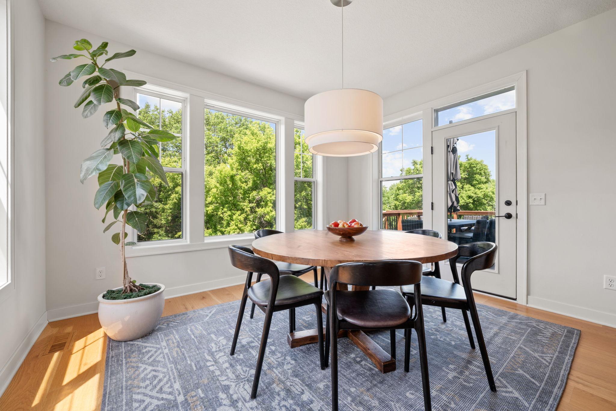 Dining Room features abundance of windows that offer panoramic views + patio door with access to the deck and property