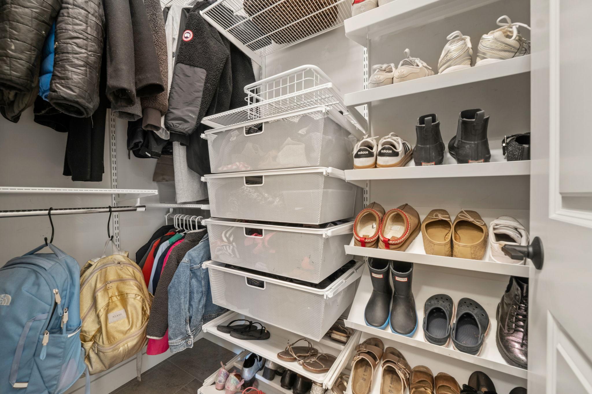 Mudroom features walk-in storage closet and luxury vinyl tile flooring