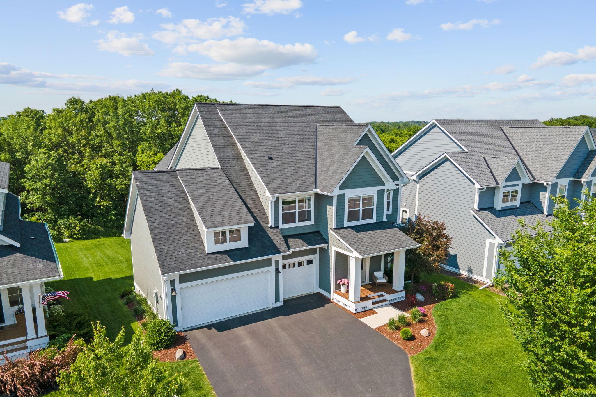 Five bedrooms across three finished levels, a three-car garage, and a lot that backs to wooded parkland — this home in The Harvest shines.