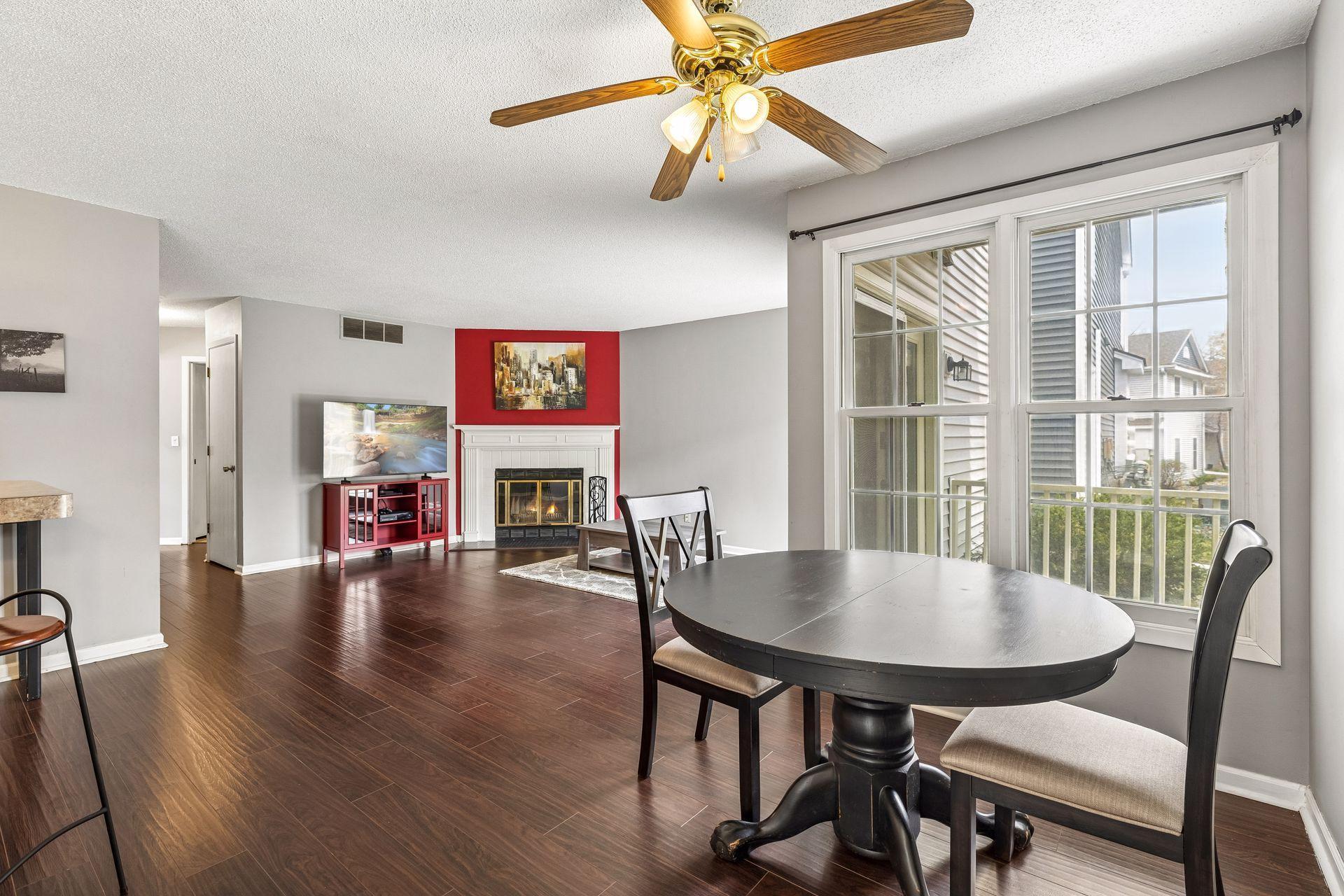 Open living/dining room with fireplace and private patio!