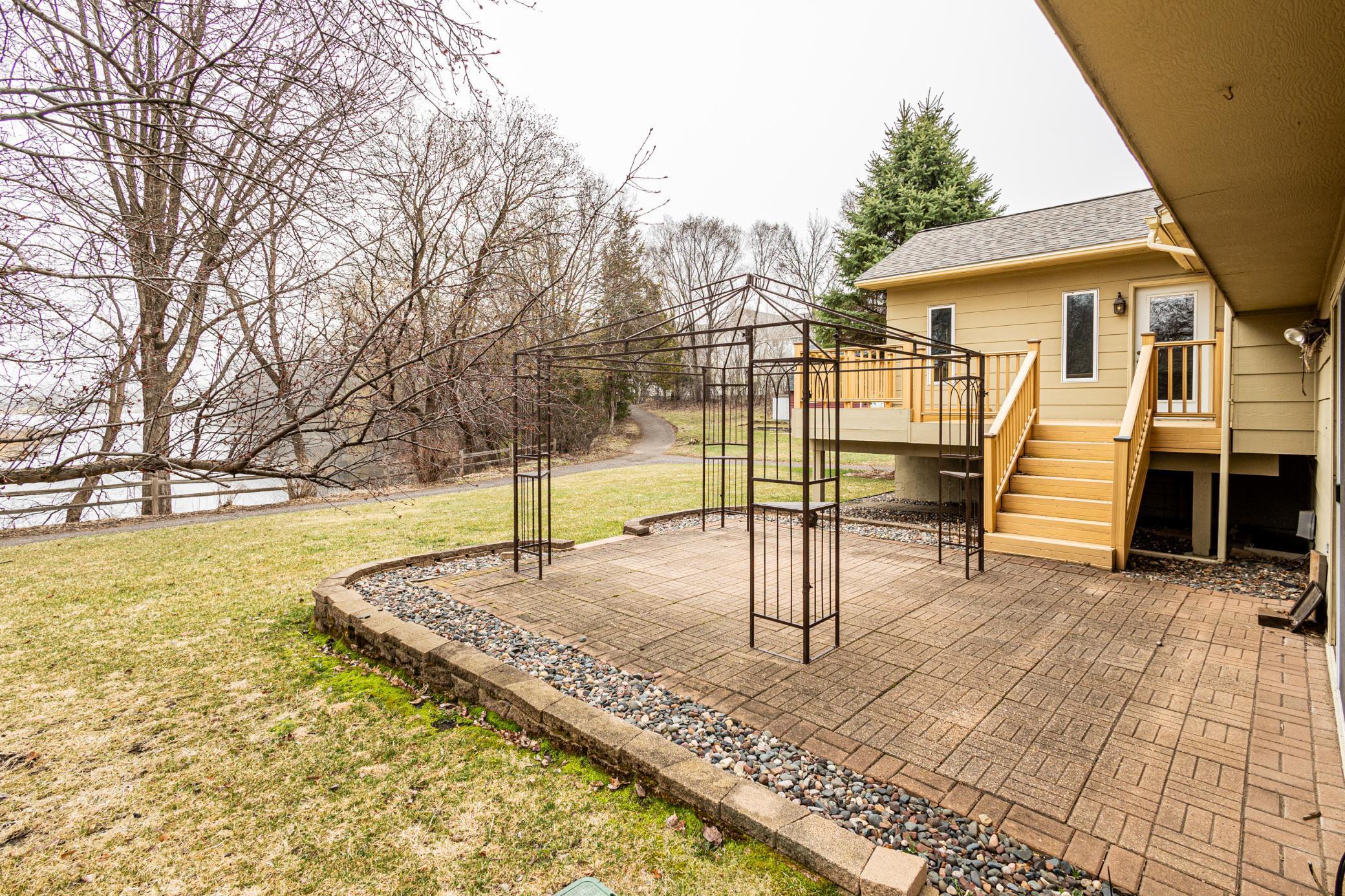Walking path runs along south side and east side of home