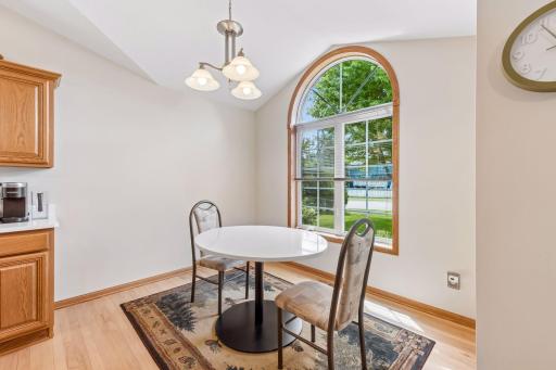 Enjoy meals surrounded by natural light in the charming dining area highlighted by a dramatic arched window and soaring ceiling.