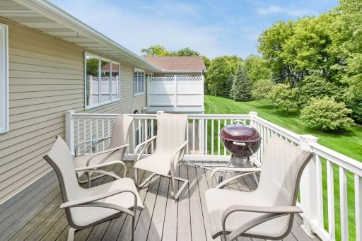 Step outside to the maintenance-friendly deck and take in the scenic views of the beautifully maintained grounds. A perfect extension of the living space for grilling, relaxing, or enjoying the outdoors.